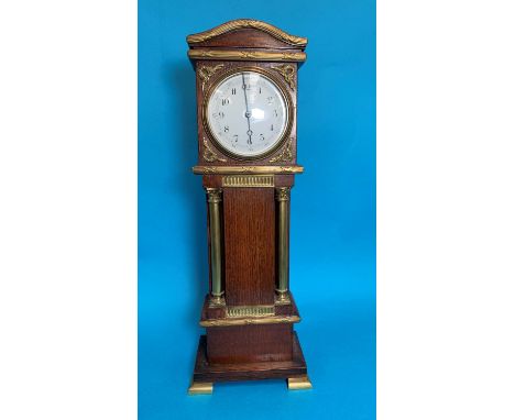 A 19th century oak miniature longcase clock with reeded brass moulding, Corinthian columns and bracket feet, white enamel dia