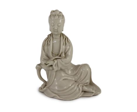 A Chinese blanc-de-chine seated figure of Guanyin, Dehua kilns, 19th/20th century,holding a ruyi sceptre in her left hand and