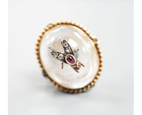 A Victorian, yellow metal and cabochon rock crystal? set dress ring, with central gem set bug motif, size R/S, gross weight 1