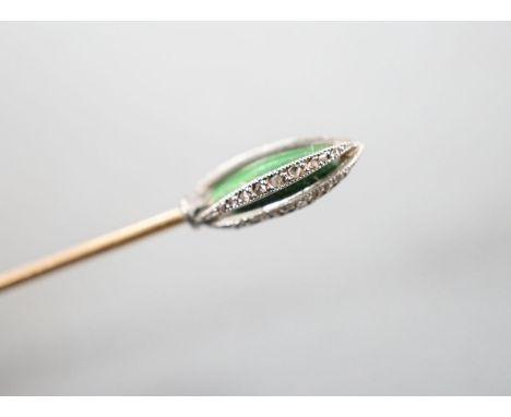 An early 20th century yellow metal stick pin, with rose cut diamond and green enamel set terminal, 76mm, gross weight 2.3 gra