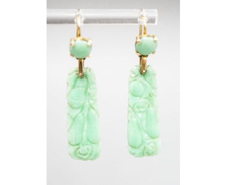 A pair of yellow metal mounted carved jade drop earrings, 43mm, gross 6.8 grams.