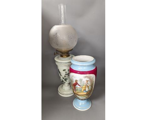 A late 19th century French enamelled green glass oil lamp and glass shade and a Paris porcelain vase,Oil lamp 61 cms high.