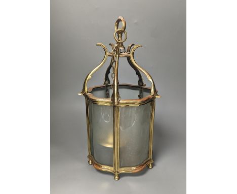A brass hall lantern and a circular brass ceiling light fitting,hall lantern 40 cms high.
