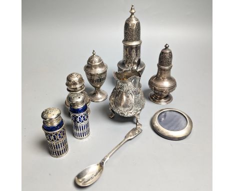 A Victorian embossed silver cream jug, London, 1883, 92mm, two 18th century silver pepperettes, one with plated cover, four l