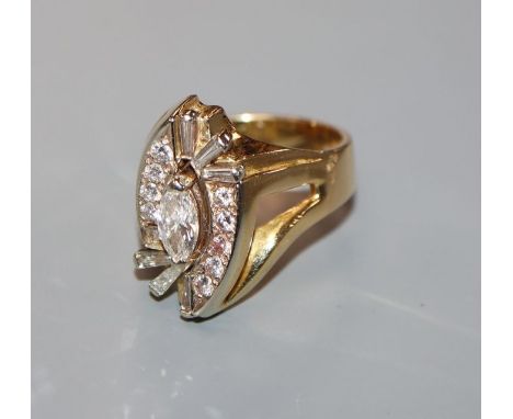 A modern 18k yellow metal, marquise, round and trapeze cut diamond set dress ring, size R/S.