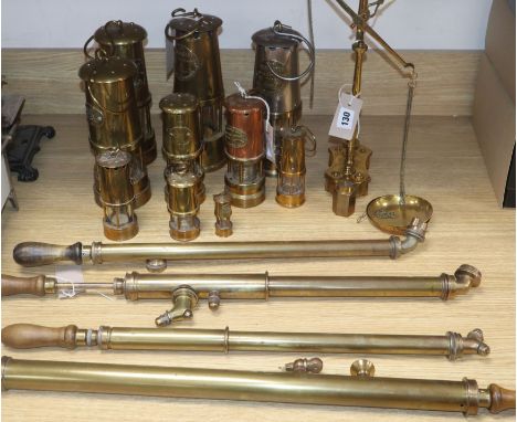 Ten reproduction and miniature brass Davy lamps, four brass garden sprayers and a set of brass balance scales and weights (Q)