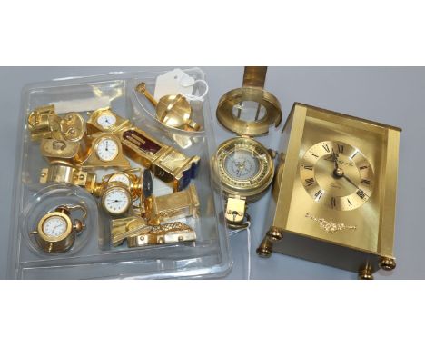 A collection of twelve novelty miniature brass clocks, a modern brass compass by Ross and a quartz gilt brass carriage clock