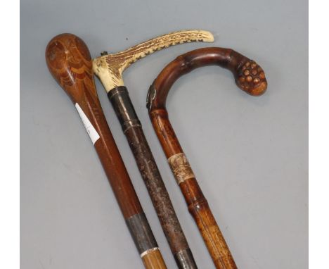 A horse measuring walking stick, stickware walking stick and a silver mounted riding crop