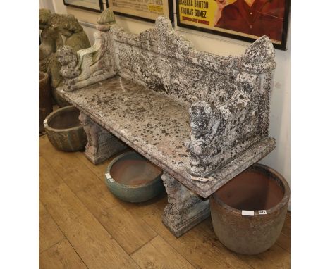 An Egyptian style reconstituted stone garden bench W.154cm