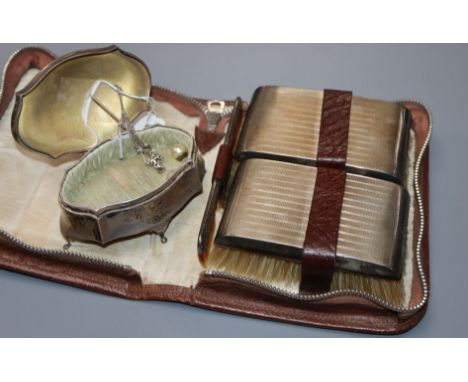 A gentlemen's silver-mounted grooming set in leather case and a silver engine-turned shaped oval trinket box.