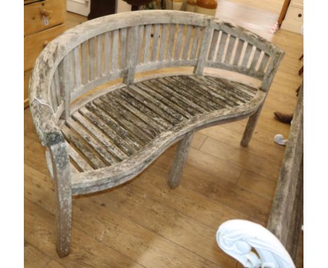 A weathered teak garden 'banana' bench W.150cm