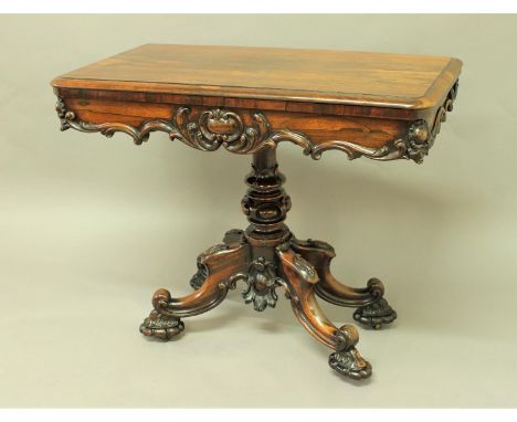 VICTORIAN ROSEWOOD FOLDOUT CARD TABLE the twisting top on a turned and carved column and scrolling quadripartite base, height