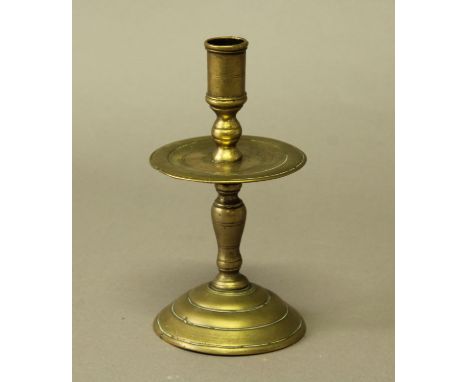 DUTCH BRASS HEEMSKERK CANDLESTICK 17th century, the turned sconce above a dish drip tray, baluster column and domed foot, hei