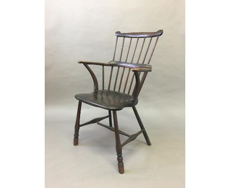 COMB BACK WINDSOR CHAIR mid 19th century, ash and elm, with a horse shoe arm rest with scrolled terminals, solid seat and tur