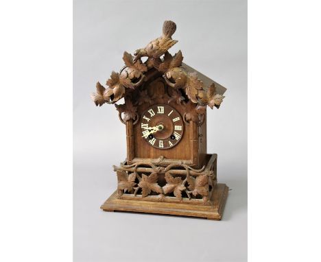 BLACK FOREST CUCKOO CLOCK late 19th century, the 5 1/2" dial with Roman numerals on a brass, eight day repeating movement hal
