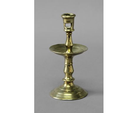 BRASS HEEMSKIRK CANDLESTICK late 17th or 18th century, with pierced sconce, central drip tray and domed foot, height 21cm