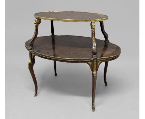 FRENCH TWO TIER ETAGERE each tier of shaped oval form, with gilt brass rams head mounts and brass edging, the lower shelf wit