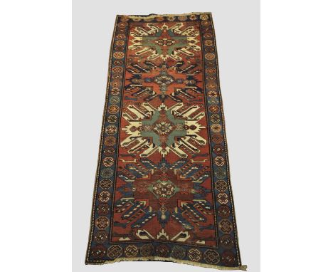 KARABAGH RUNNER South Caucasus, late 19th century, the madder field with three sunburst medallions framed by mid indigo borde
