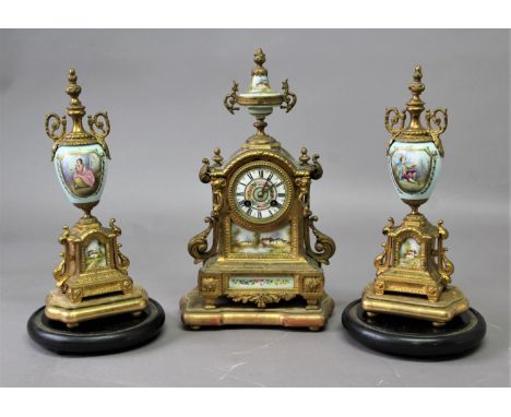 FRENCH GILT METAL AND PORCELAIN MOUNTED CLOCK GARNITURE the 3" dial painted with flowers on a brass, eight day movement strik