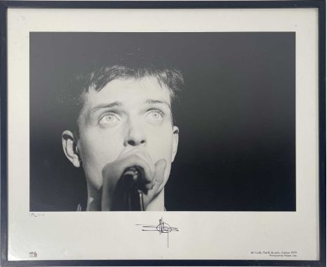 A photograph depicting Ian Curtis, onstage at Plan K, Oct 1979. Signed to border by photographer Philippe Carly. From an edit