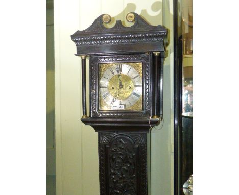 Antique carved oak eight day longcase clock having brass and silvered dial