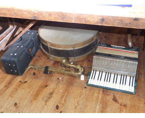 Hohner piano accordion, large drum, saxophone and trumpet
