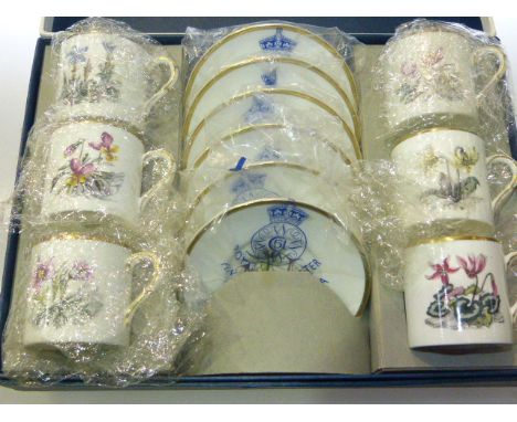 A set of six Royal Worcester botanical coffee cans and saucers, boxed