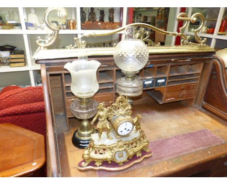 Two brass oil lamps, ormolu and alabaster ornate figural mantel clock and Victorian brass fender