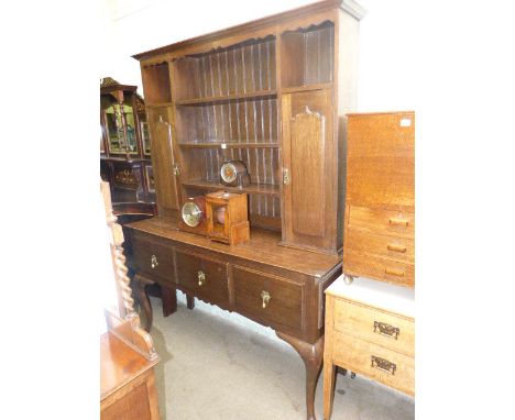 Early 20th Century oak three drawer cabriole leg dresser with shelf and cupboard back