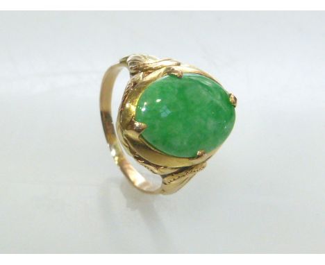 Jadeite ring, the oval jadeite four claw set above leaf shoulders, unmarked, size M, jadeite 15mm by 10mm