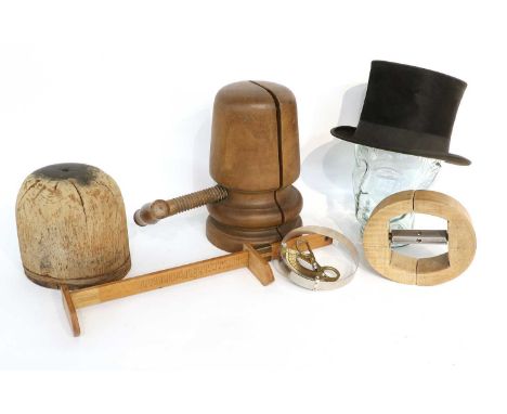 Millinery Tools comprising hat stretcher, hat mould, measurer, black silk top hat (a.f.) and other itemsThe Milliner's Workro