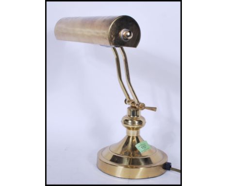 A vintage / retro 20th Century brass bankers desk lamp,&nbsp;having an adjustable brass shade raised on a brass support and c