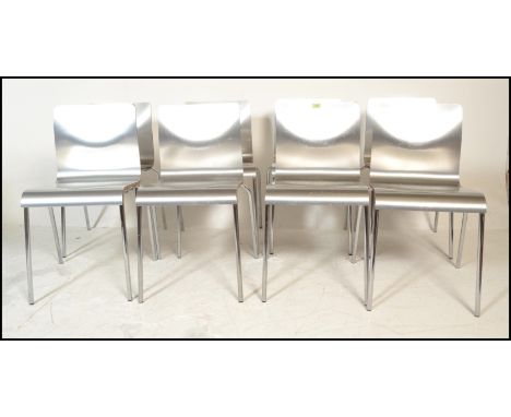 A set of eight panel stacking dining&nbsp; chairs, the chairs panels having a silvered finish raised on chrome tubular suppor