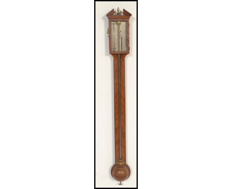 A 19th Century Georgian oak stick barometer. The silvered dial marked for J Powell Worcester. Having cup and cover base with 