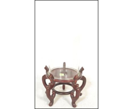 A large 20th Century glass display dome being raised on a carved Chinese hardwood stand. Ideal for use with a clock or taxide