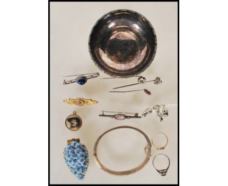 A collection of jewellery dating from the 19th Century onwards to include a stamped 9ct gold mourning brooch being set with s