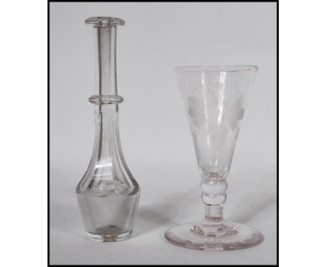 A 18th / 19th Century Georgian cut glass toddy lifter together with a Georgian etched wine glass raised on a large circular b