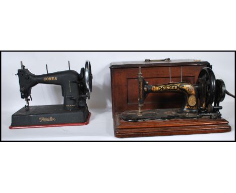 A vintage cased early 20th century Singer sewing machine complete in tha carry box together with another sewing machine marke