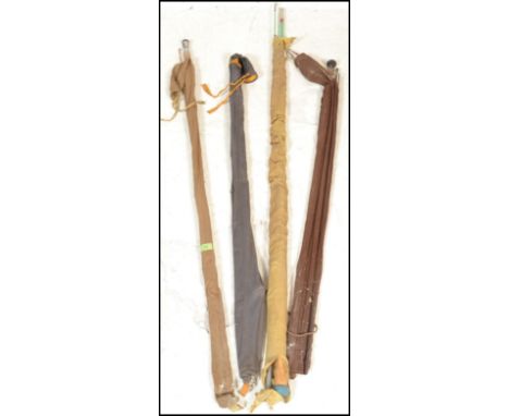 A collection of four vintage fishing rods to include split cane, fly rods etc. All in original canvas cases.