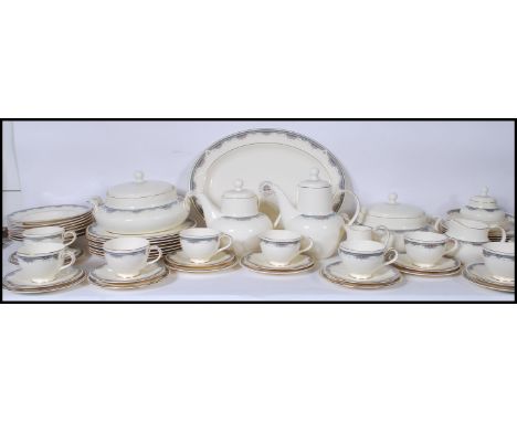 A 20th Century dinner and tea service by Royal Doulton in the Albany pattern having ivory white ground with floral decorated 