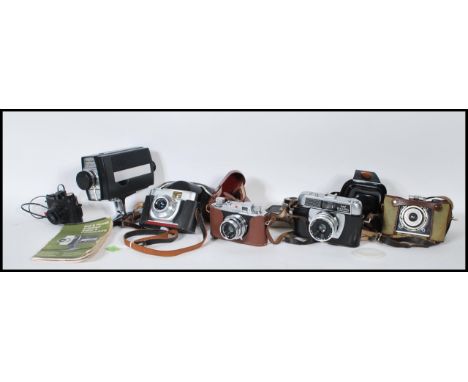 A collection of 20th Century vintage cameras to include Empire Baby the wonder boxed camera, Bell and Howell Autoload super 8