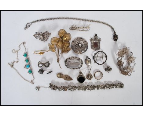 A collection of silver and silver white metal jewellery to include a an unengraved fob medal with an armorial cartouche, a st