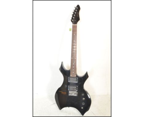 A heavy metal style six string electric guitar made by Stagg, finished in black having having chrome tuning pegs with fret ma