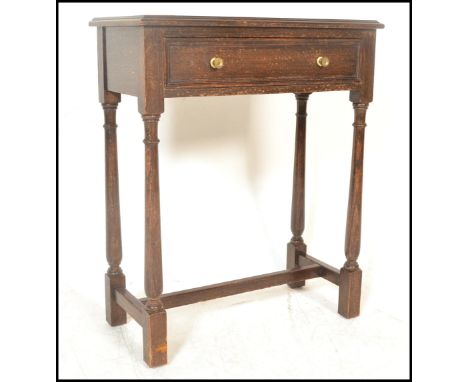 A vintage 20th Century Jacobean revival Bartholomew and Fletcher oak side table, single drawer under the frieze, raised on tu