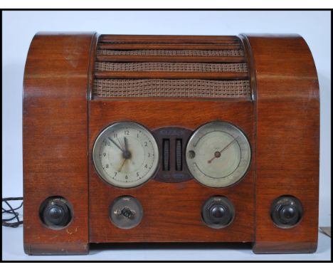 A vintage mid 20th Century walnut cased Goblin&nbsp; "Time Spot" valve radio, featuring a 8-inch Plessey speaker and a clock-