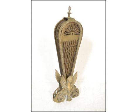 An early 20th century peacock fan fireguard having fold out brass fan sections with pierced decoration and finial top. 65cms 