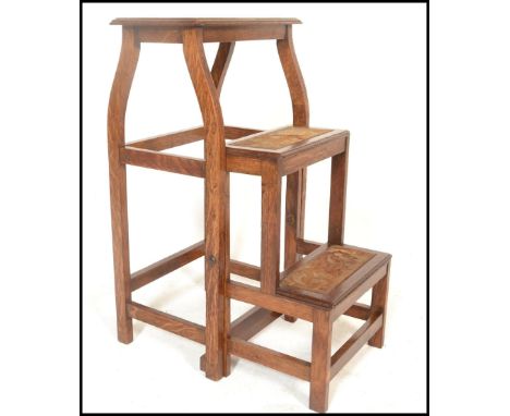 An early 20th Century Arts and Crafts metamorphic folding set of library steps / ladder, the three step ladder retaining orig