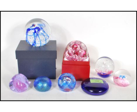 A collection of 20th Century paperweights, mostly by Caithness to include Mooncrystal, Fleur, Pebble, a Langham bubble paperw