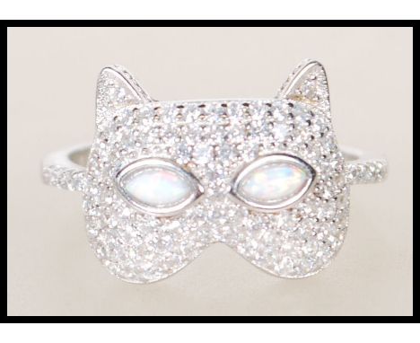 A silver CZ and opalite ladies dress ring in the form of a cats head being set to a plain shank. Total weight 4.32g / Size R