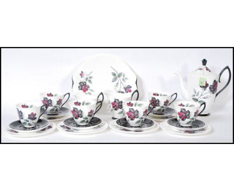 A Royal Albert coffee service in the Masquerade pattern comprising of cups, saucers, side plates, coffee pot, cake plate and 